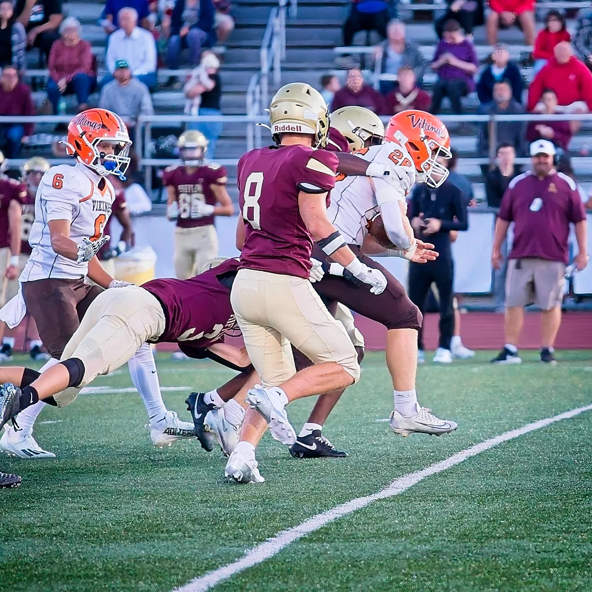 RB running down the field with the defense after them